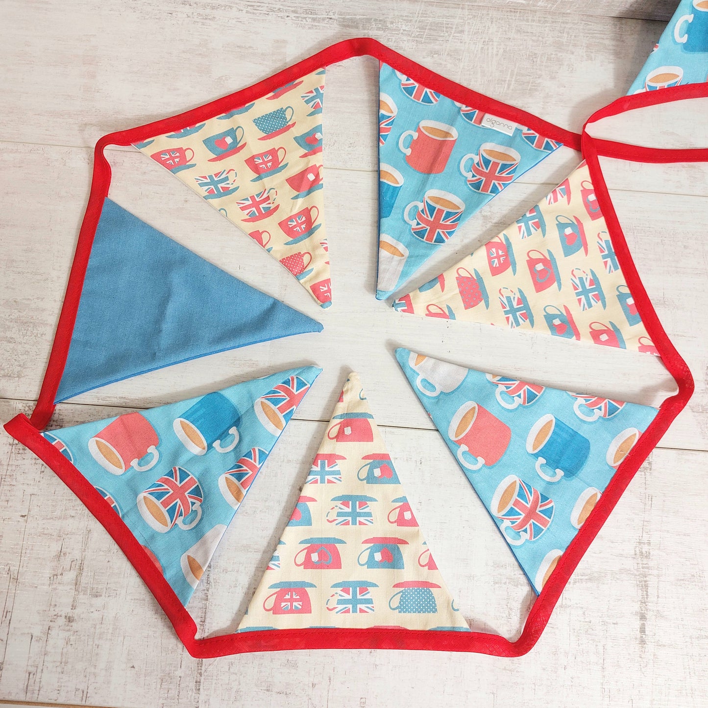 Blue, red and cream bunting flags with mugs of tea on for the Queens jubilee